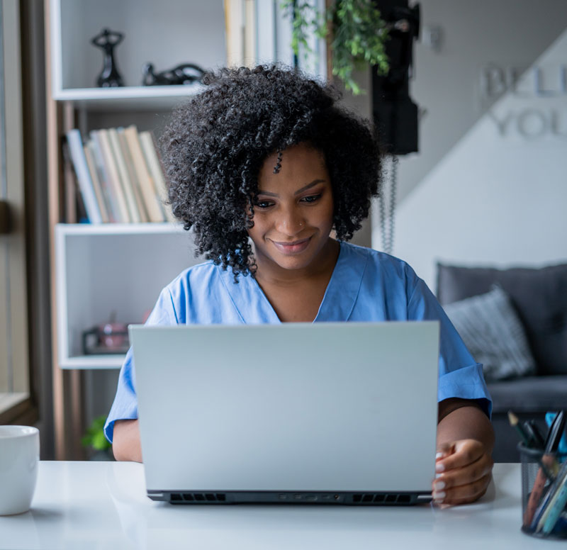 Woman working on a laptop.